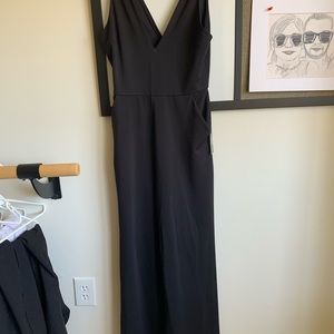 Black express jumpsuit! Unworn! Low cut with pockets